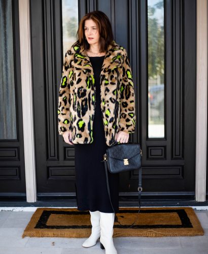 Over 40 women wearing black dress, leopard faux fur coat, white boots for date night