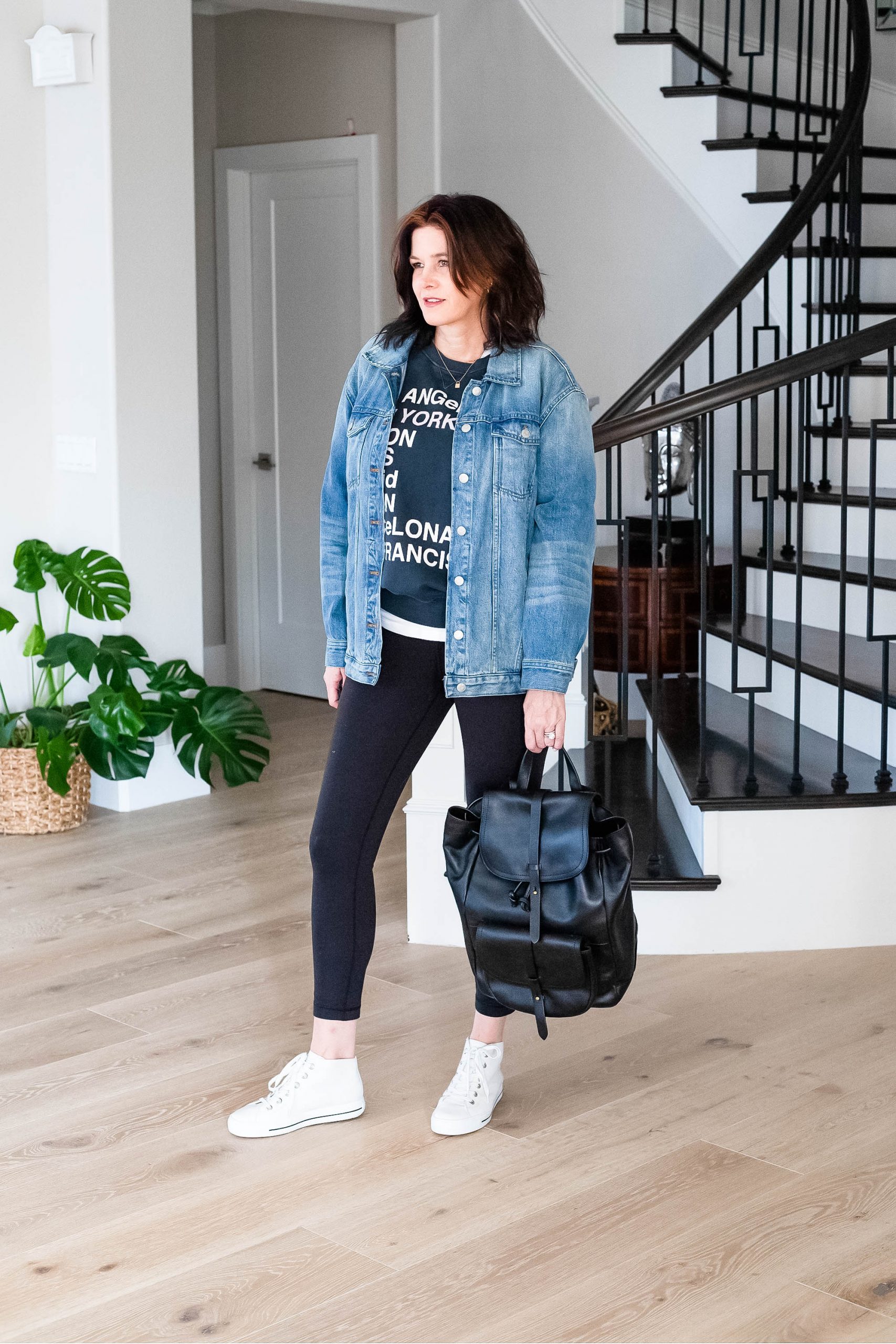 Over 50 women wearing graphic sweatshirt, leggings and sneakers