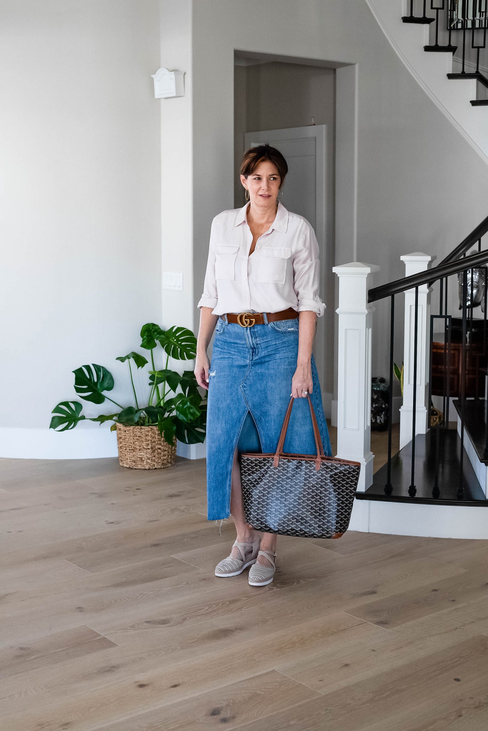 Over 50 women wearing long denim skirt with button up top and sandals