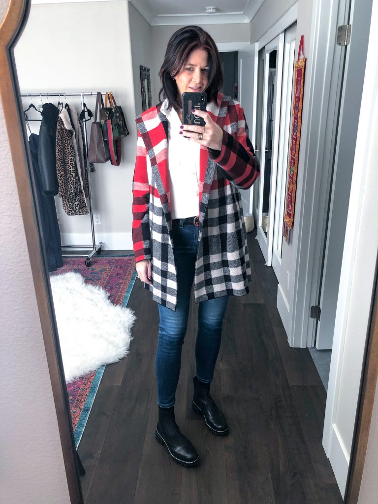 Midlife women with rag and bone chelsea boots, ag jeans, sweater coat mirror selfie