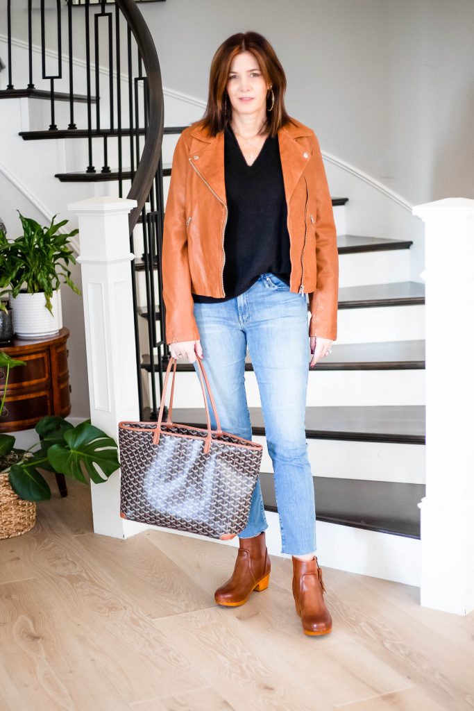 Over 50 Women in Moussy denim jeans, Madewell leather jacket with Goyard Tote