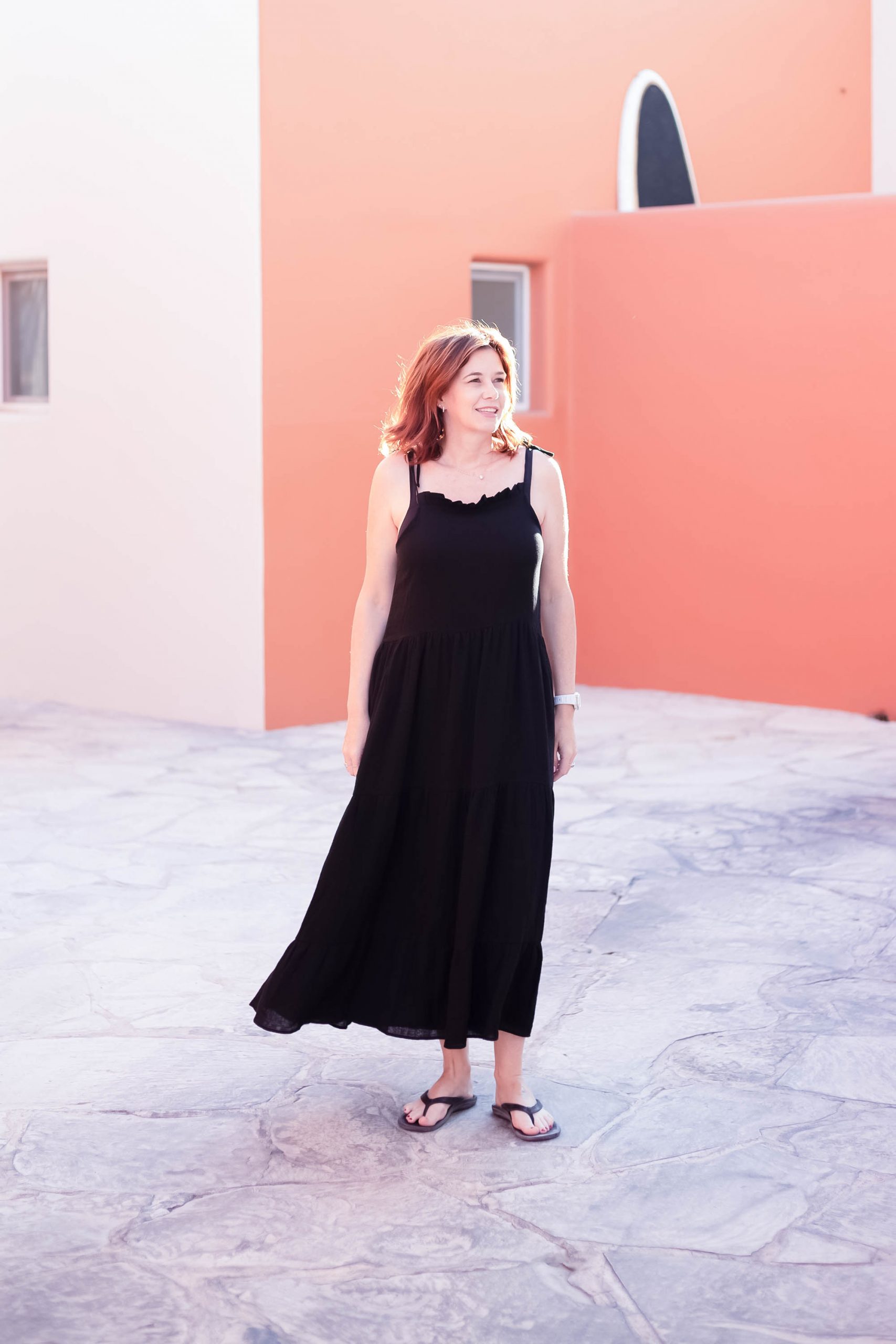 midlife women wearing Anine Bing black maxi dress and flip flops in La Paz Mexico