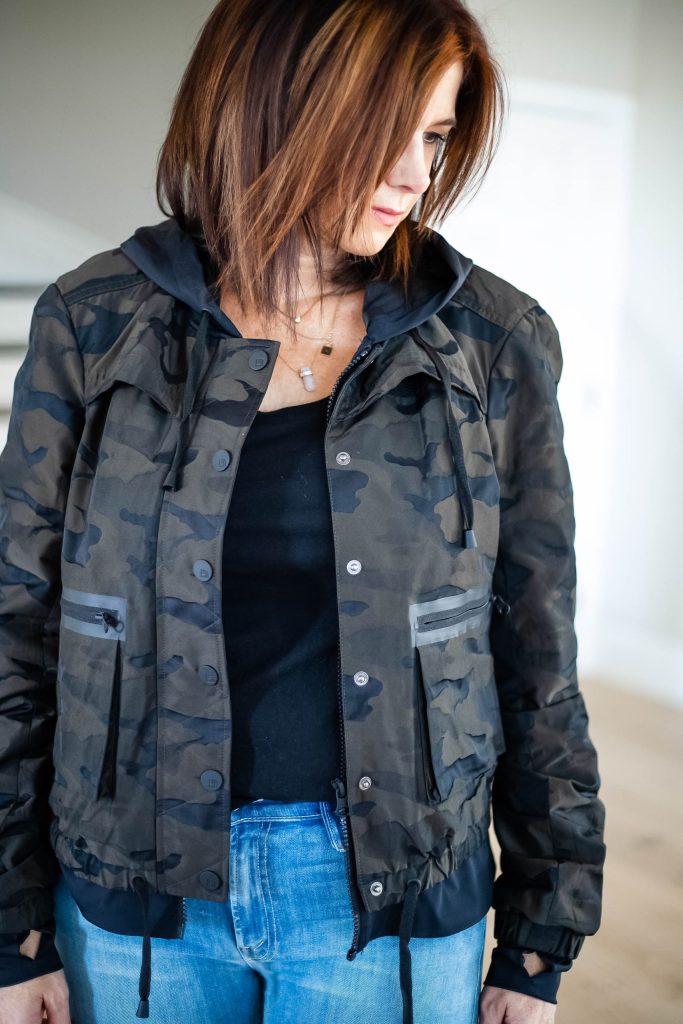 StyleDahlia wearing camo jacket, black tee shirt, jeans and sneakers.