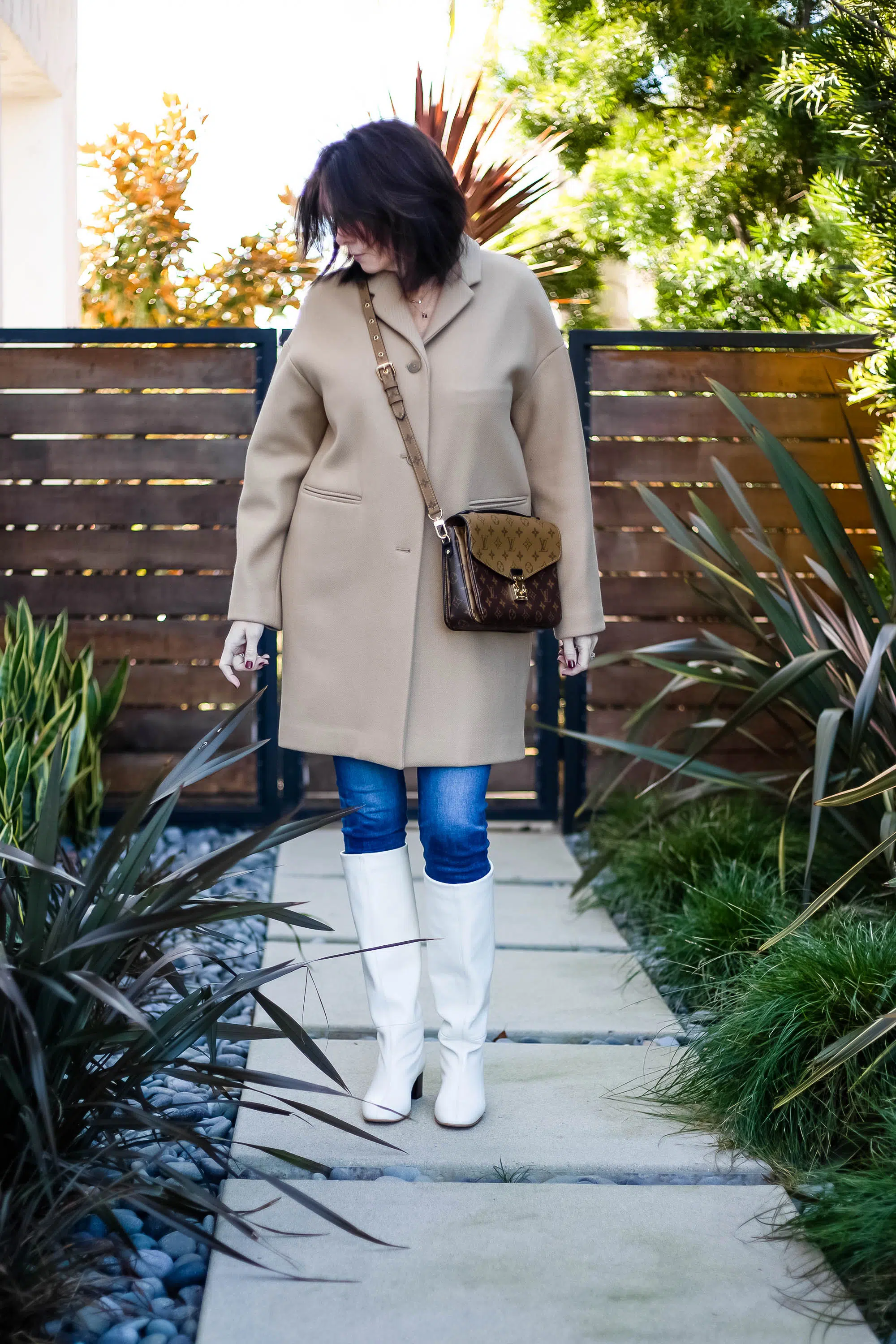 Over 40 women wearing Everlane tan coat with cream Everlane boots