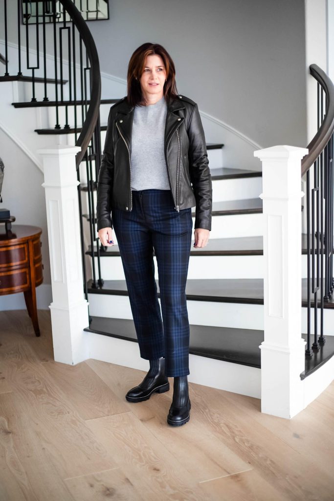 IRO leather jacket, grey sweater, plaid pants and boots on women at stairs