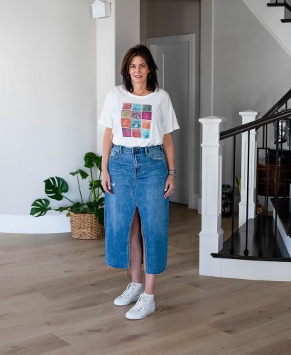 Over 40 women wearing long denim skirt with graphic tee and high tops