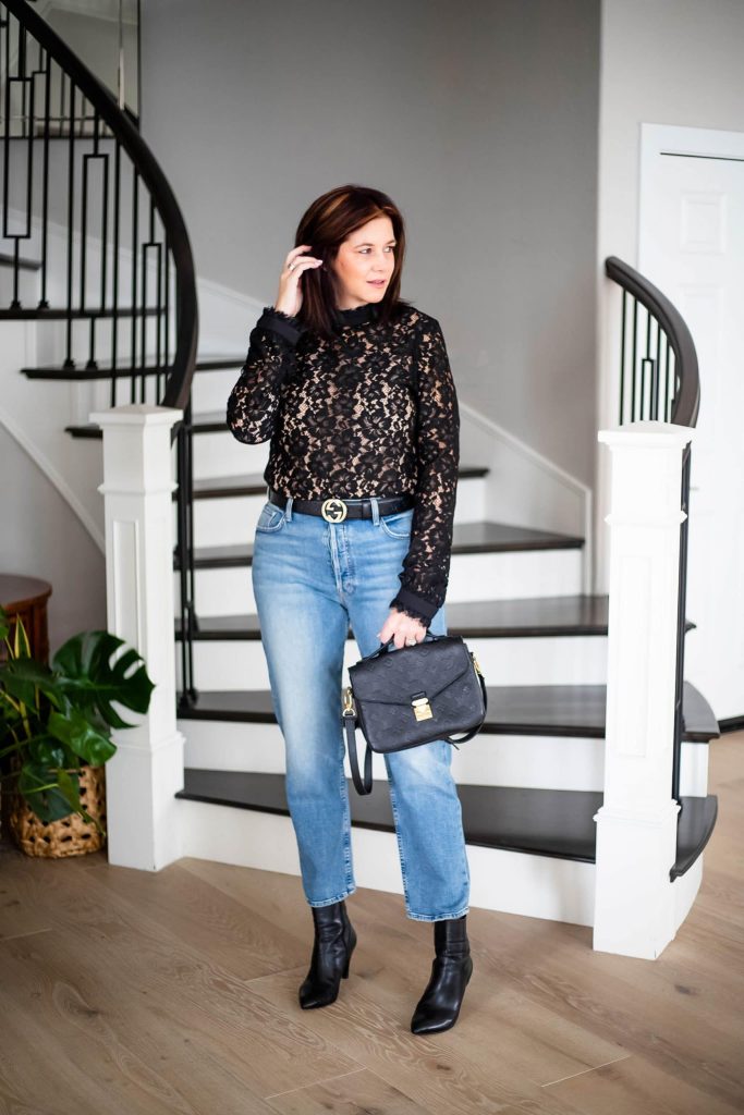 Over 50 women wearing lace top with straight leg denim and boots