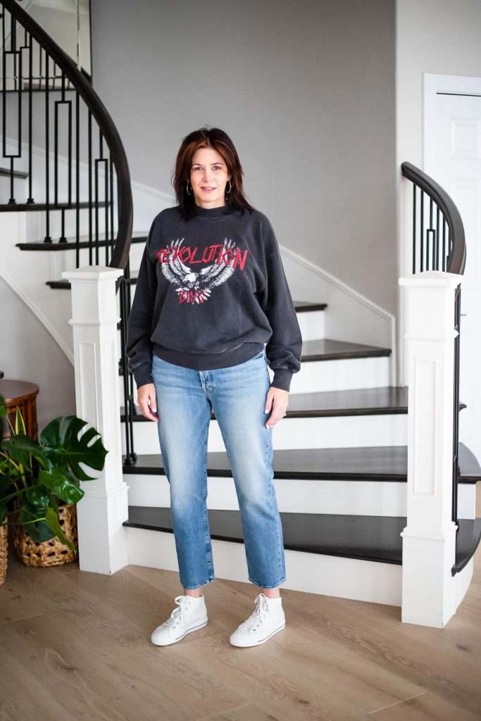 Over 50 women wearing graphic sweatshirt, jeans and sneakers