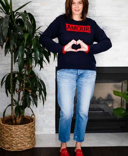 Over 40 women wearing Sundry Amour Sweater, straight leg jeans and Gucci slides for Valentines Day