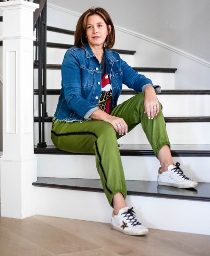 Over 50 women wearing satin joggers, graphic tee, L'agence denim jacket and sneakers