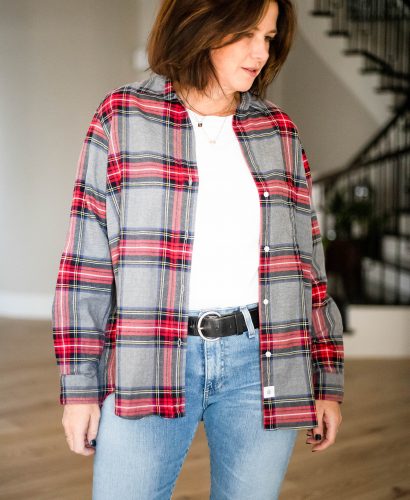 Midlife women wearing flannel shirt, white tee, jeans and sneakers