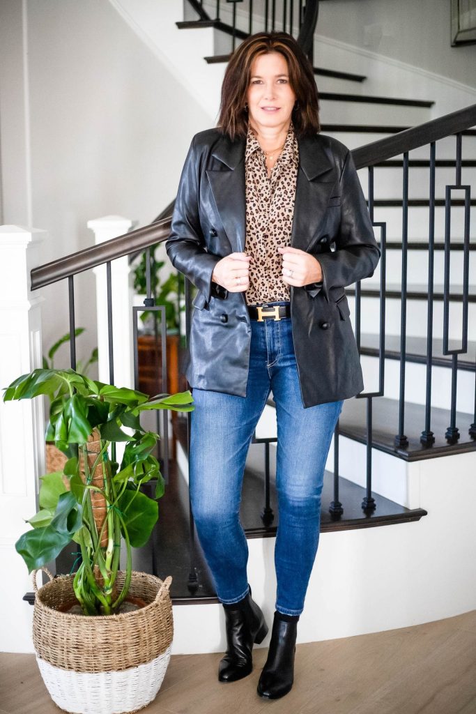 Midlife women wearing faux leather blazer, leopard shirt, jeans and boots
