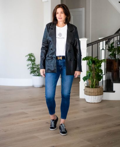 Midlife women wearing faux leather blazer, Tee and jeans