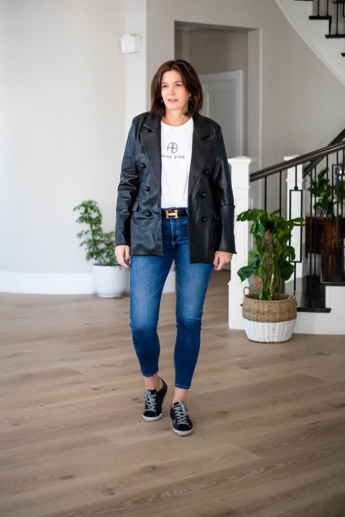 Midlife women wearing faux leather blazer, Tee and jeans