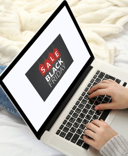 Woman using laptop on her bed