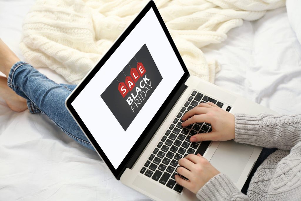 Woman using laptop on her bed