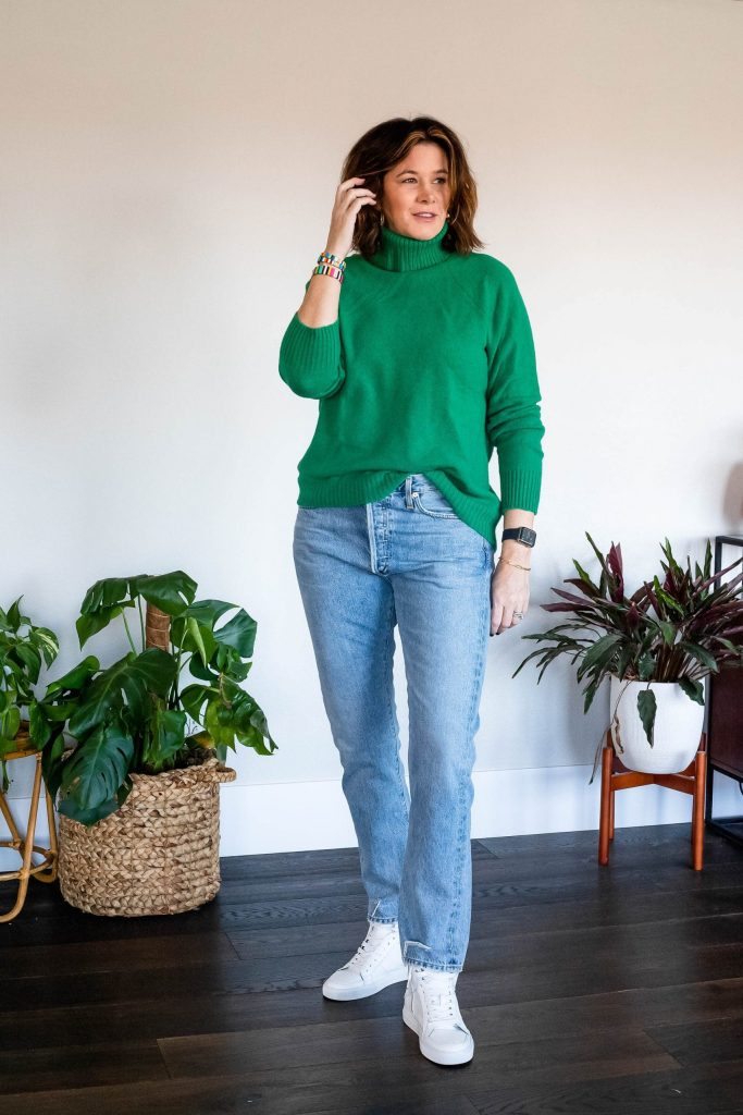 Women wearing J.Crew turleneck sweater, Citizen oversized jeans and Zadig & Voltaire sneakers.