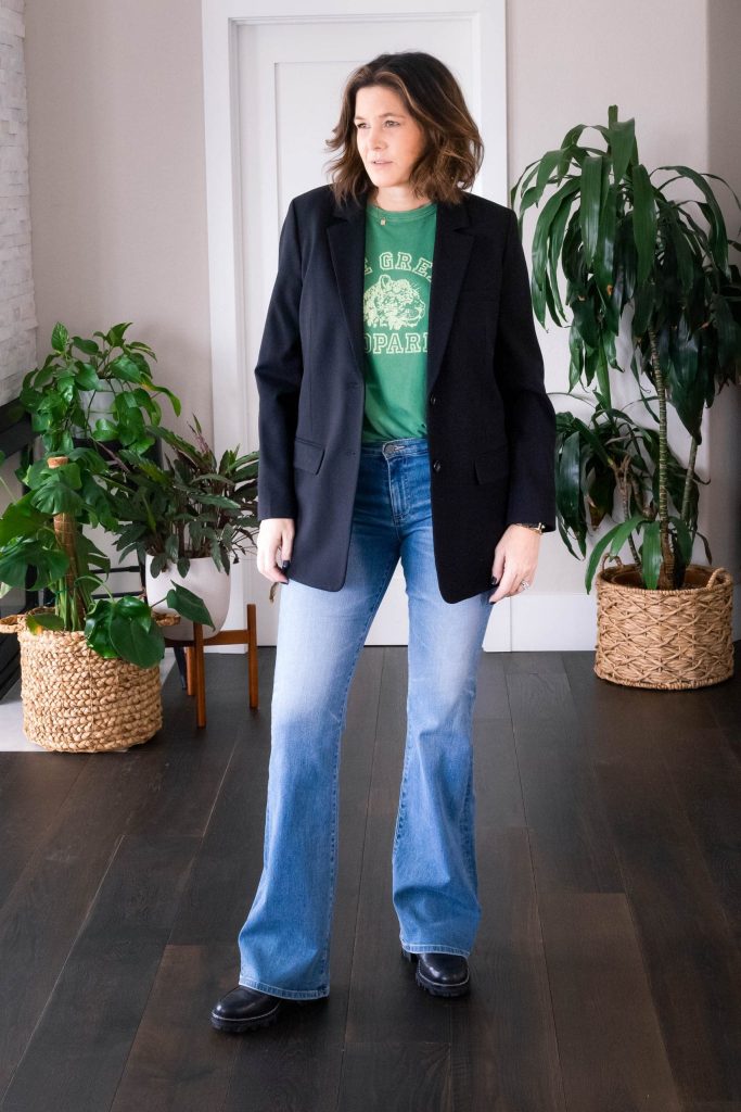 Over 50 women wearing bootcut jeans, graphic tee and blazer.