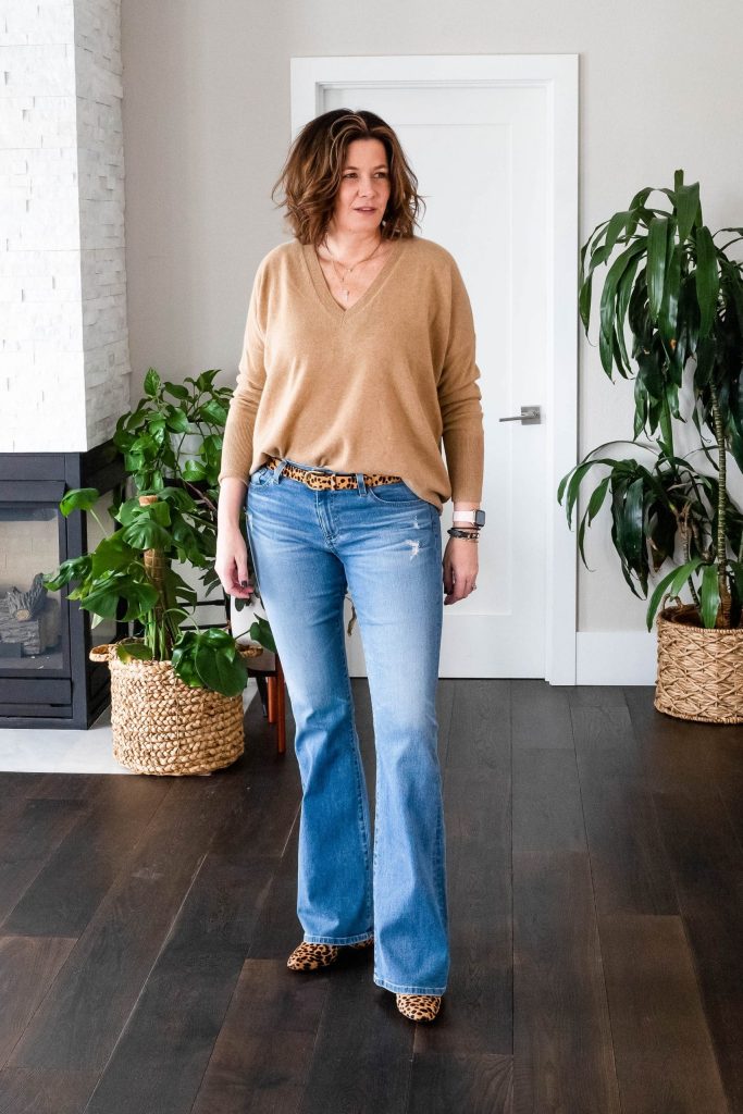 Over 50 women wearing bootcut jeans, J.Crew Cashmere sweater and Leopard booties.