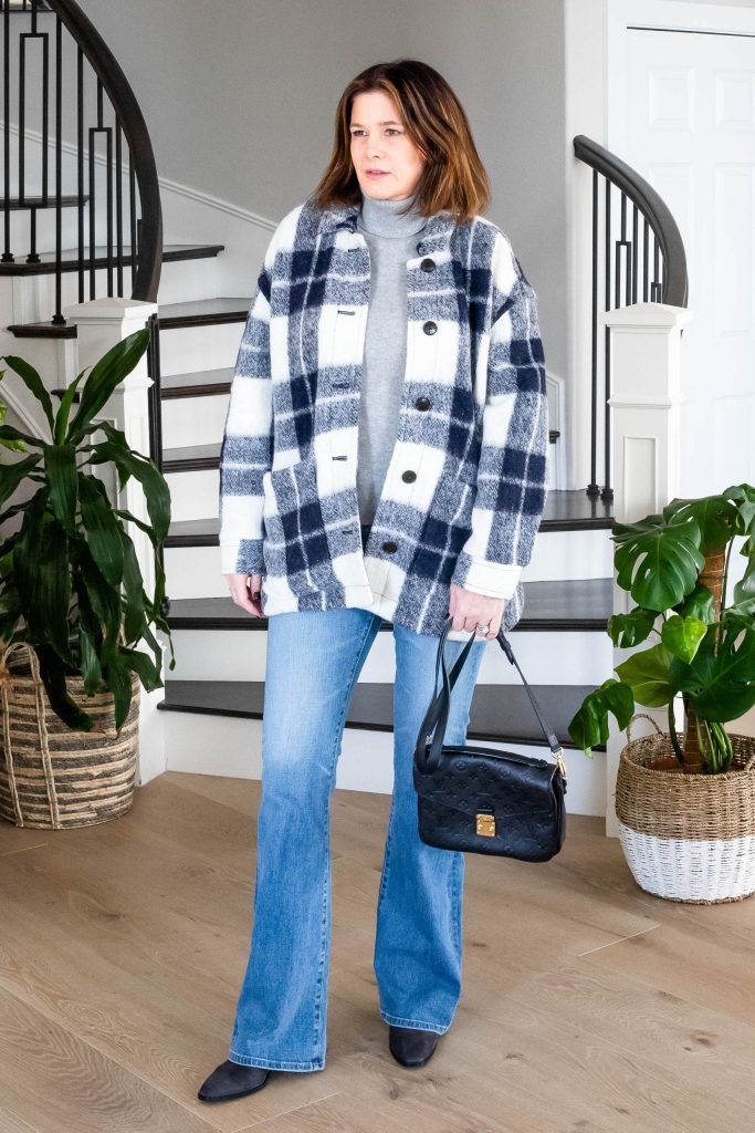 Over 50 women wearing bootcut jeans, turtleneck and plaid shacket