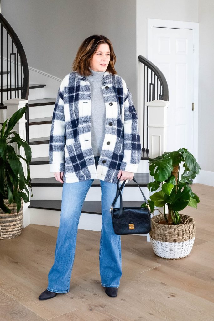 Midlife women wearing shacket, cashmere sweater and bootcut jeans