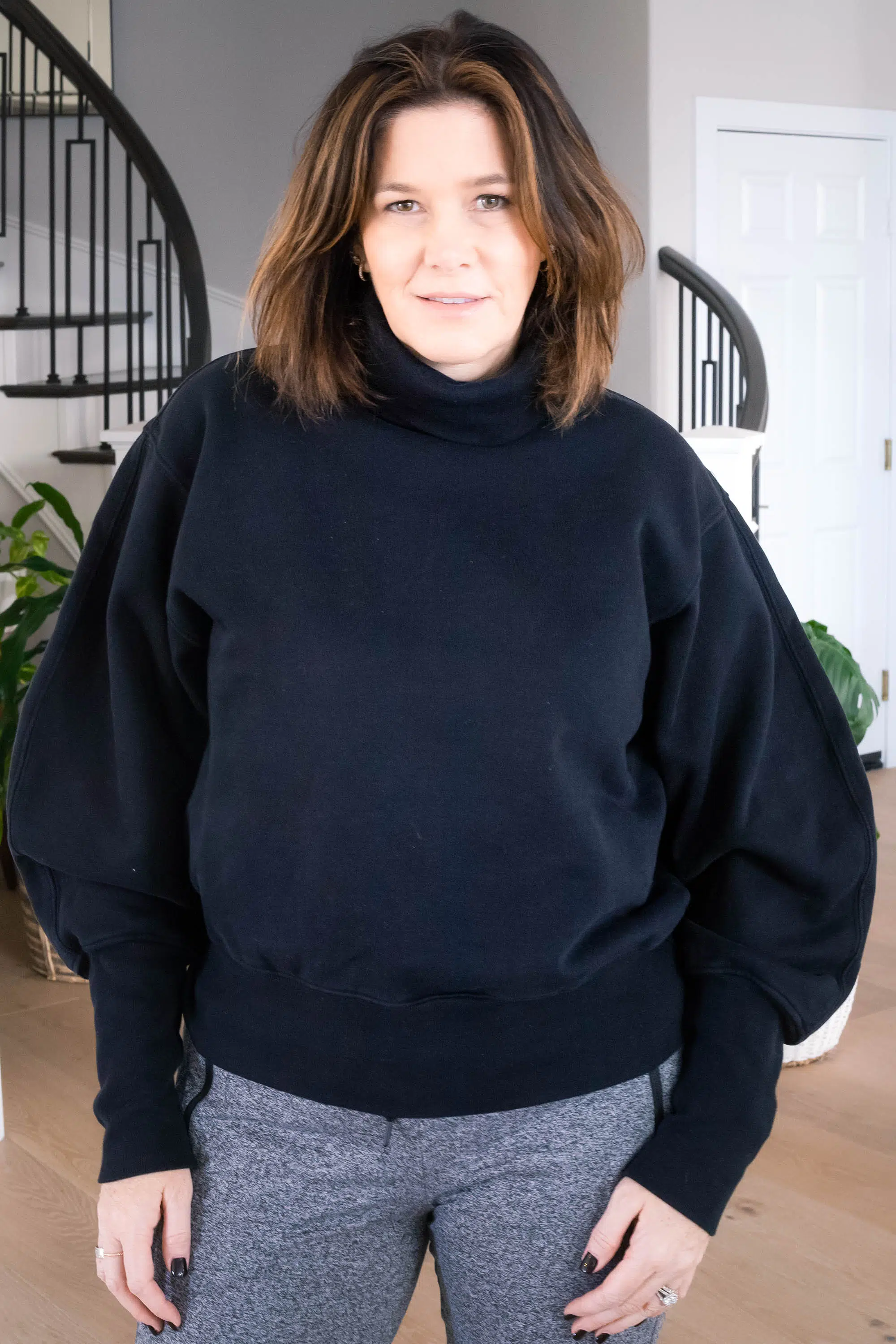 Over 50 women wearing AGOLDE sweatshirt, Zella sweatpants and Golden Goose sneakers