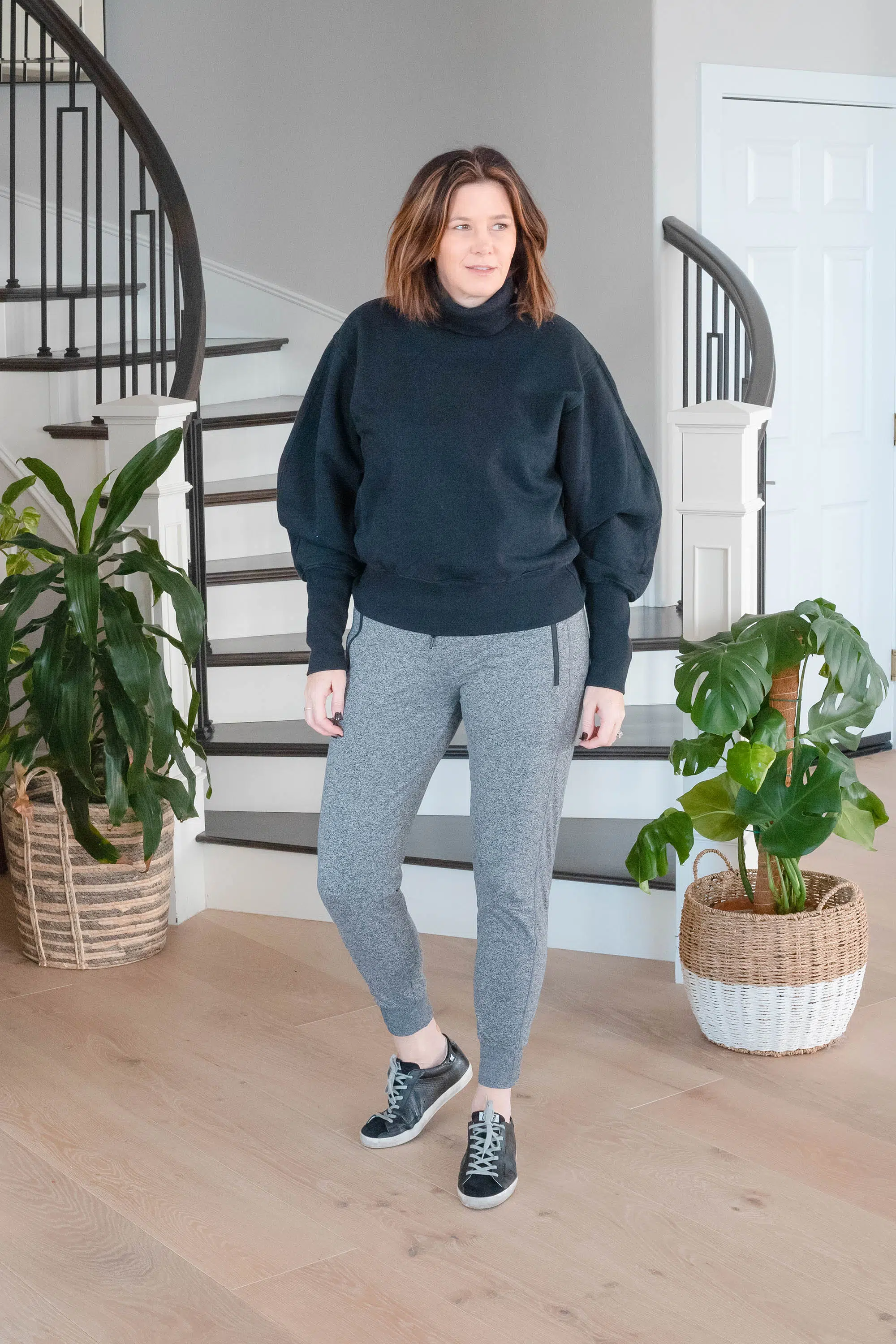 Over 50 women wearing AGOLDE sweatshirt, Zella sweatpants and Golden Goose sneakers