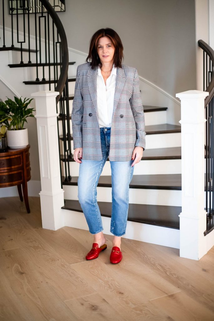 Women wearing Anine Bing blazer, white shirt, jeans and Gucci red loafers.