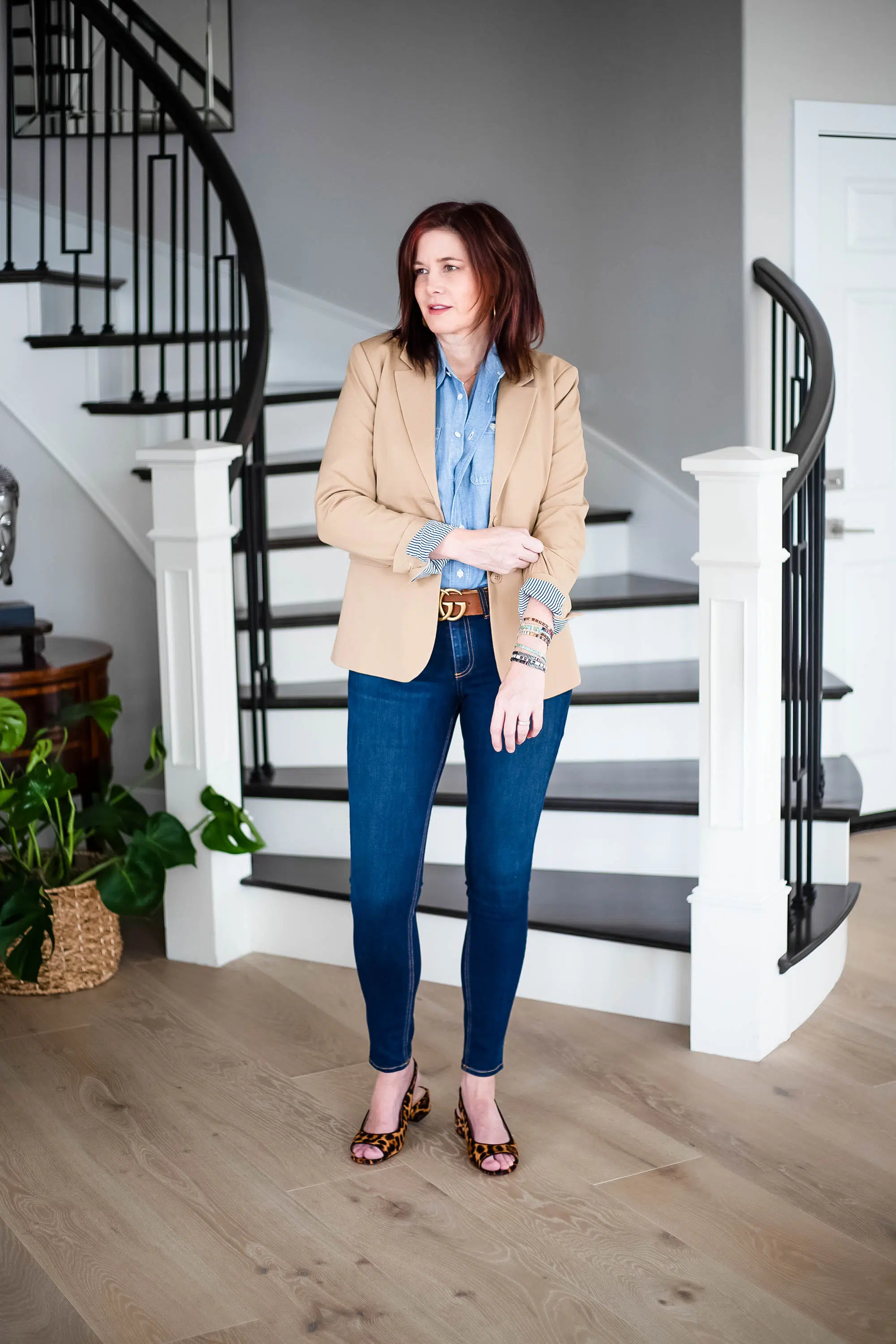 Women wearing denim top, jeans and tan blazer