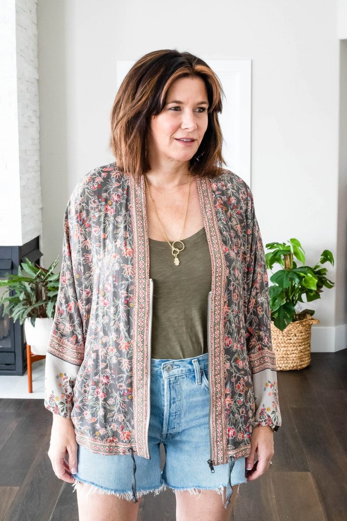Midlife women wearing Agolde Parker Shorts, tank top and Free People Kimono