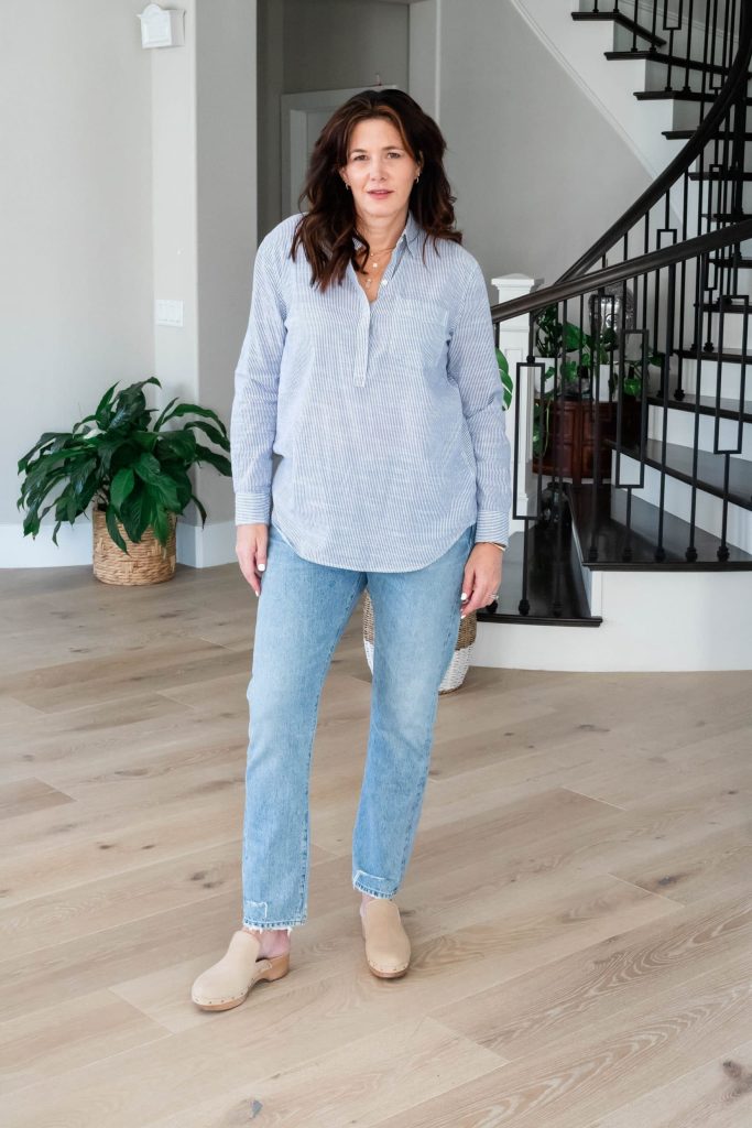 Midlife women wearing popover shirt, jeans and clogs