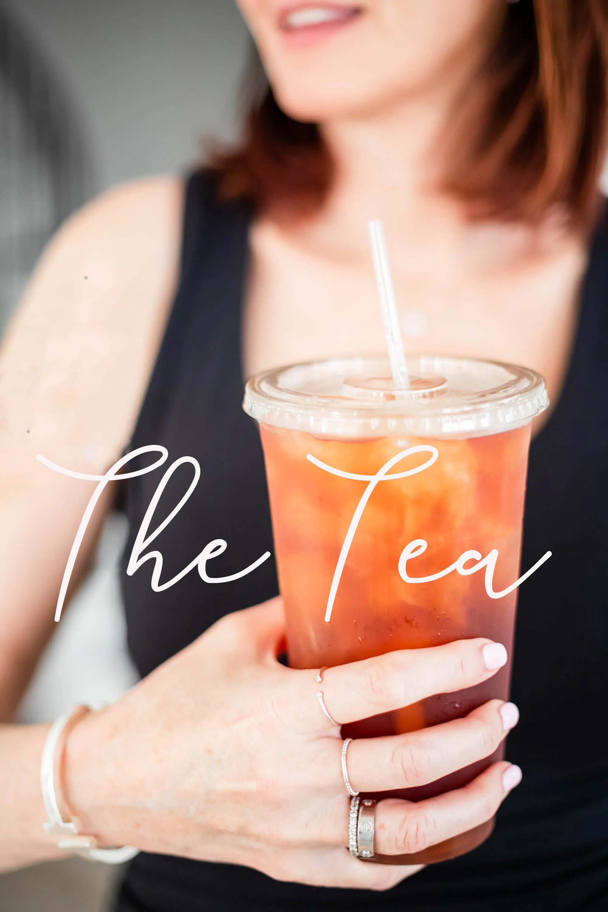 The Tea Women holding an iced tea cup