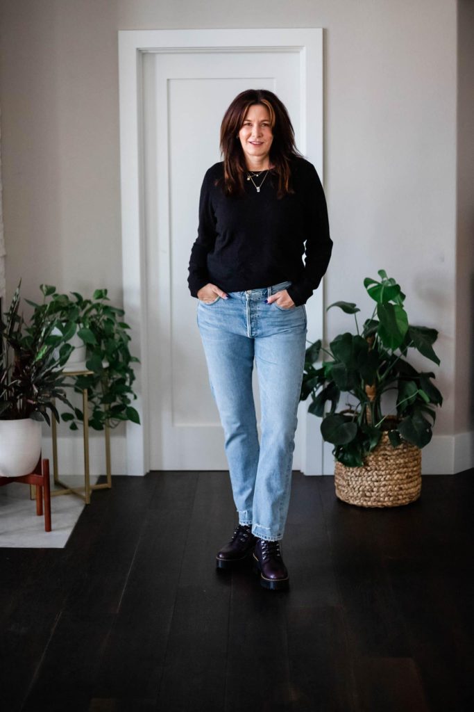 Midlife women wearing Dr. Martens, cashmere sweater and straight leg jeans.