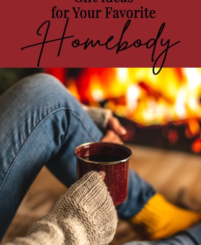Homebody in a sweater and socks is sitting next to the fireplace with cup of beverage. Concept of creating a cozy atmosphere