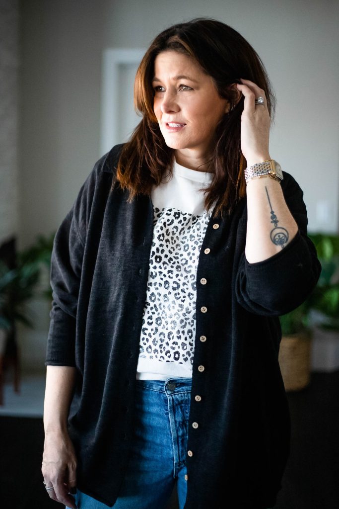 StyleDahlia wearing jeans, top of the Free People Zuma Sweater Set and graphic tee.